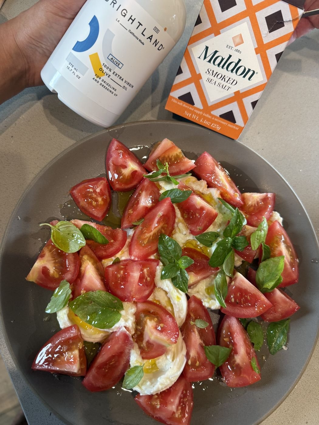 Heirloom tomatoes, burrata and basil with olive oil and flaky salt